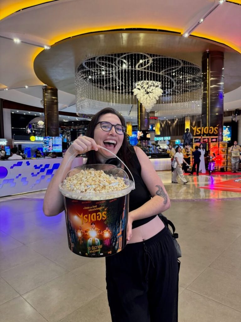 Allison Green with a giant vat of popcorn larger than her head at Siam Paragon