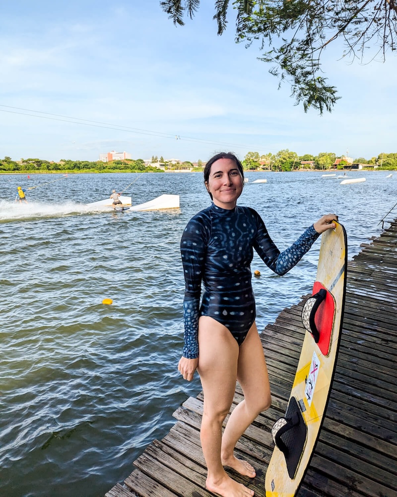 Allison Green in a bathing suit at Taco lake holding a beginner wakeboard