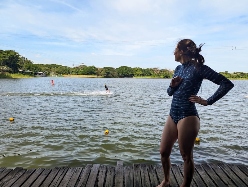 Allison wearing a swimsuit and enjoying Taco Lake watching the people wakeboard around her