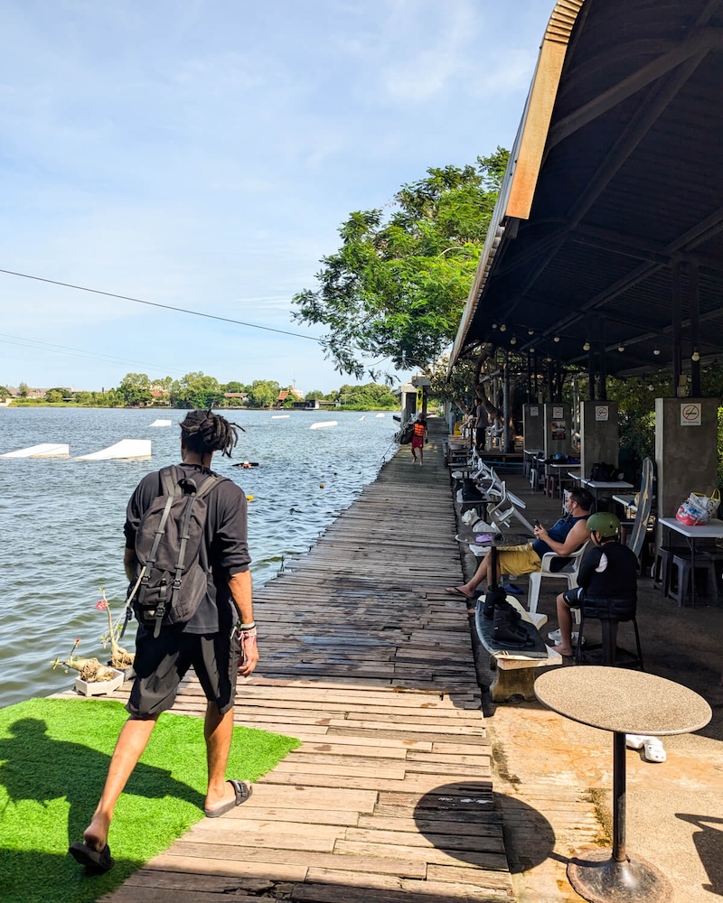 Allison's friend, who loves to wakeboard, walking towards the bathrooms and changing facilities before starting a day at Taco Lake