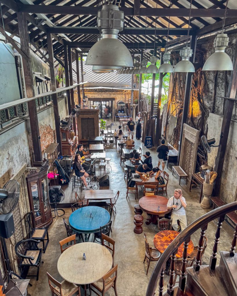 View of the people playing live music at the Hong Sieng Kong cafe as seen from up above having ascended the spiral staircase
