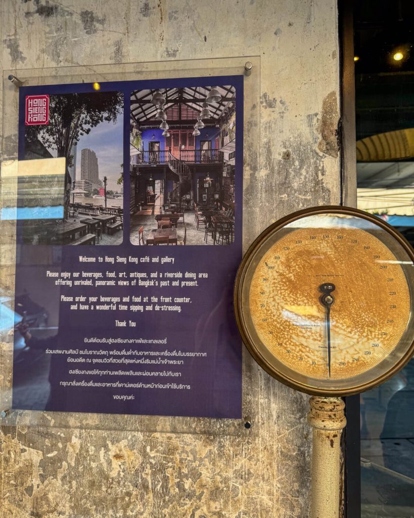 Entrance to the Hong Sieng Kong cafe with an antique scale in the front of the building