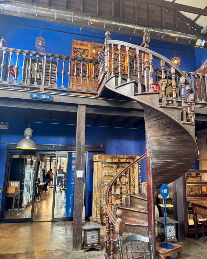 The famous spiral staircase with blue background on the Hong Sieng Kong Cafe in Talat Noi neighborhood of bangkok