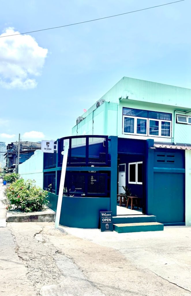 A colorful mint green exterior of the building for Taihong Coffee