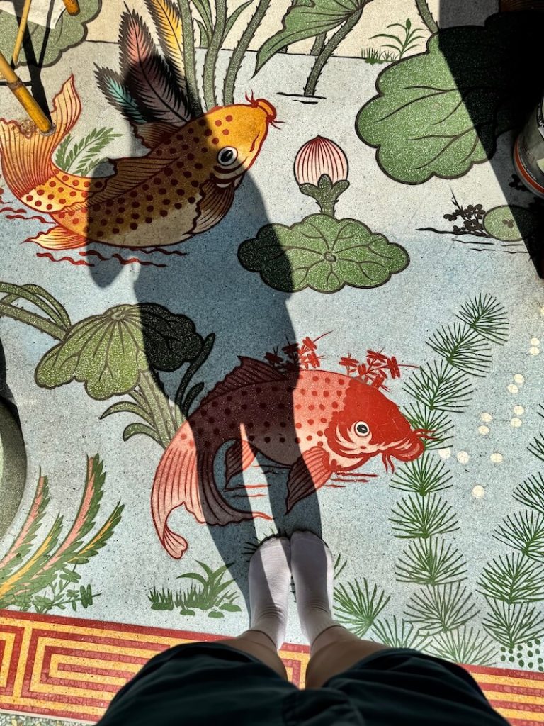 Detail of the floor tile with koi fish and lotus flowers