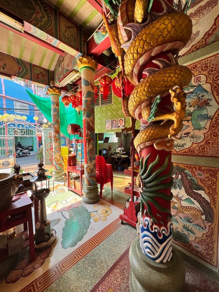 One of the pillars inside the shrine with detail and intriguing carvings looking out onto the street