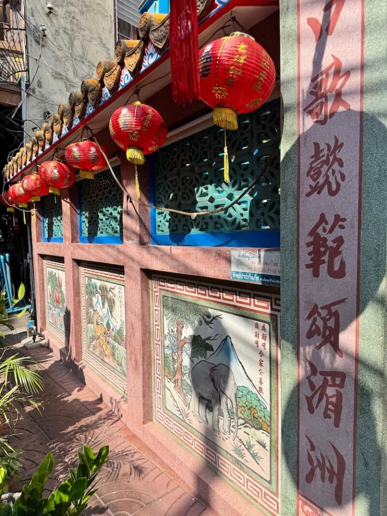 Exterior of Hok Lien Keng shrine with red lanterns and Chinese calligraphy