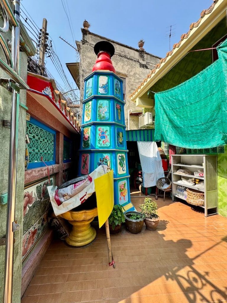 Green and blue pagoda with paintings on it at Hok Lien Keng shrine