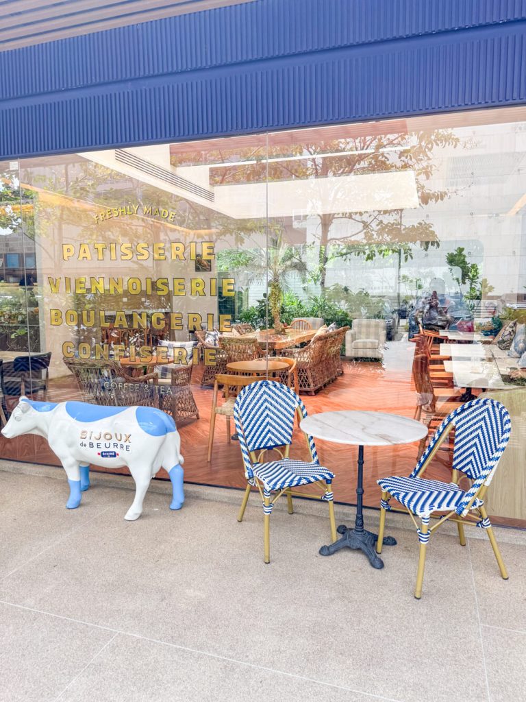Exterior seating area with the cow that is the 'trademark' symbol of this Ekkamai cafe