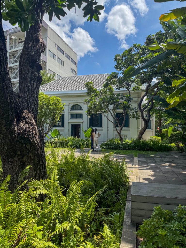 The entrance of the Neilson Hays Library with all the tropical plants in the courtyard