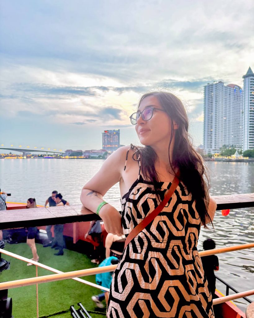 The author of the article, Allison Green, enjoying a sunset after a rainstorm on boat cruise in Bangkok