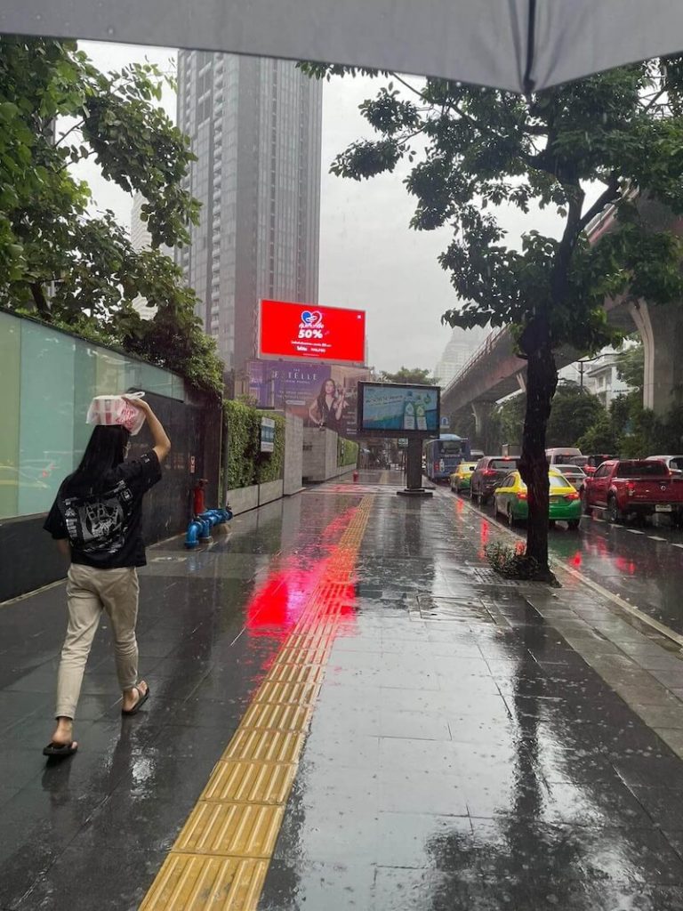 Rainy season in Bangkok with umbrella in frame